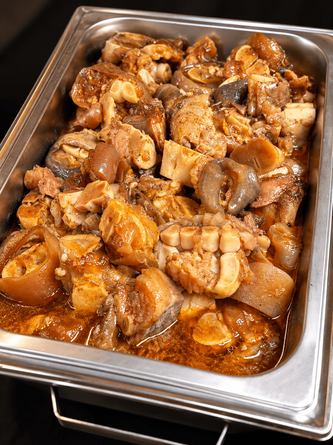 Chafing dish of slow-braised trotters in rich gravy